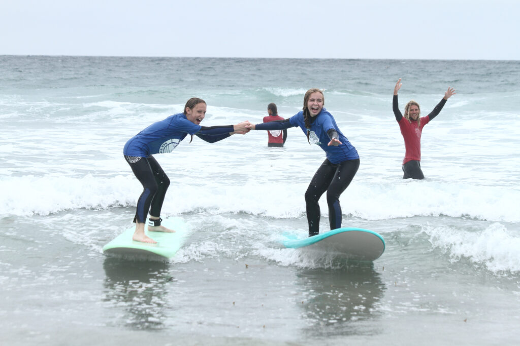 Two female surfers learning to surf together